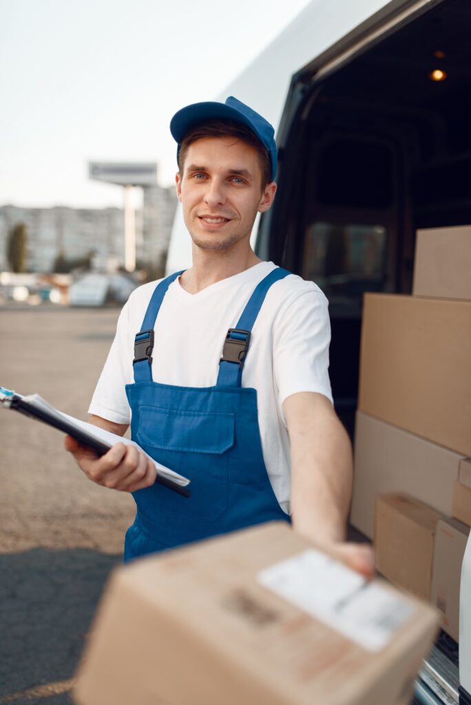 Deliveryman in uniform gives parcel, delivery